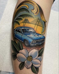 a tattoo of a blue car with a flower on it