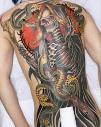 a man with a skeleton tattoo on his back