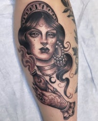 a tattoo of a woman holding a cigarette